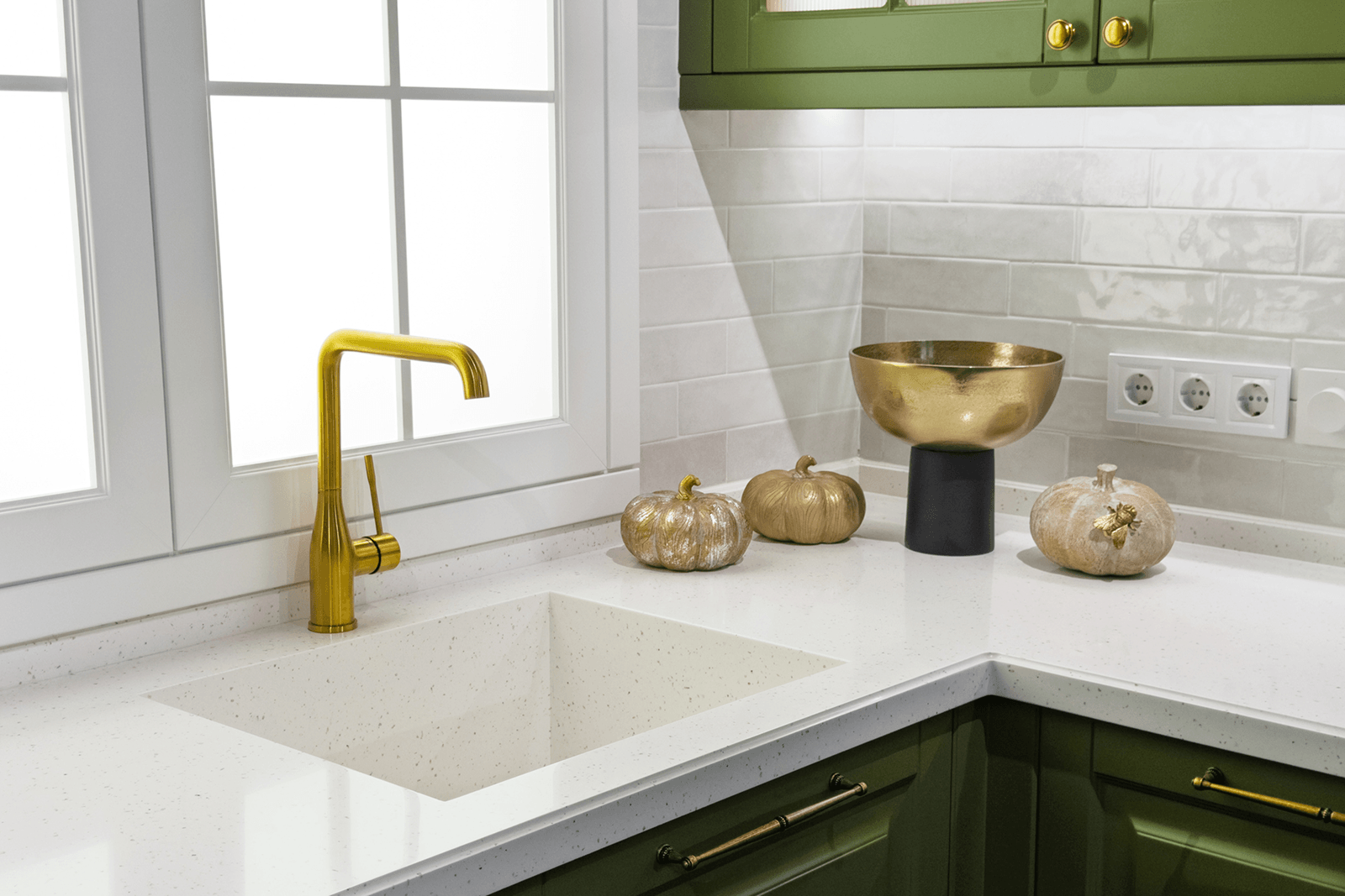 Elegant kitchen scene featuring stylish decor and modern faucet with decorative pumpkins